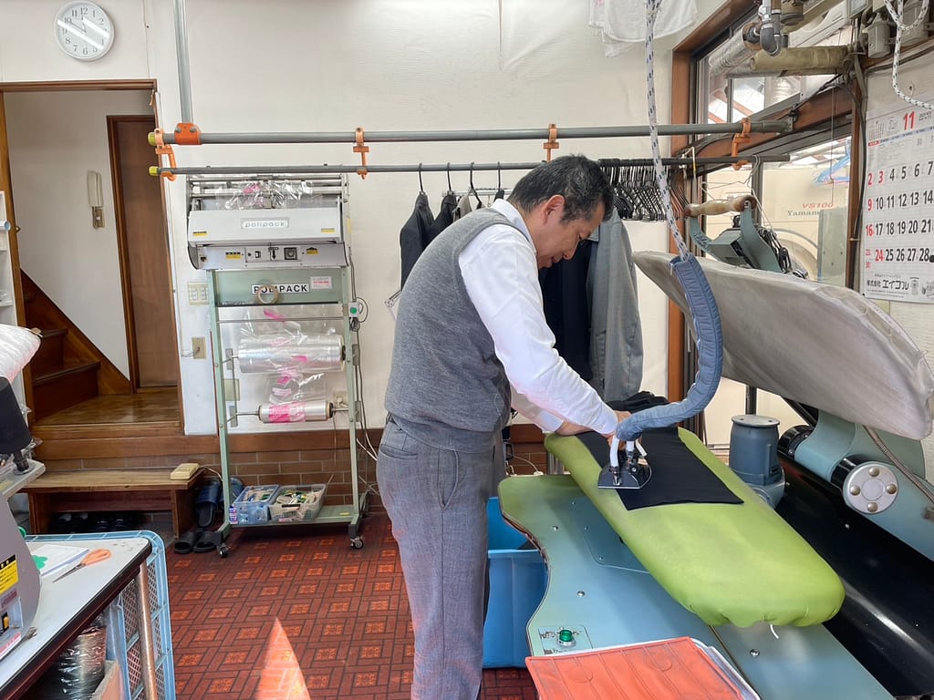 新生クリーニング アイロン仕上げ 作業風景 一点ずつ丁寧な手仕上げ